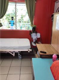 kid looking through the window of a hospital room